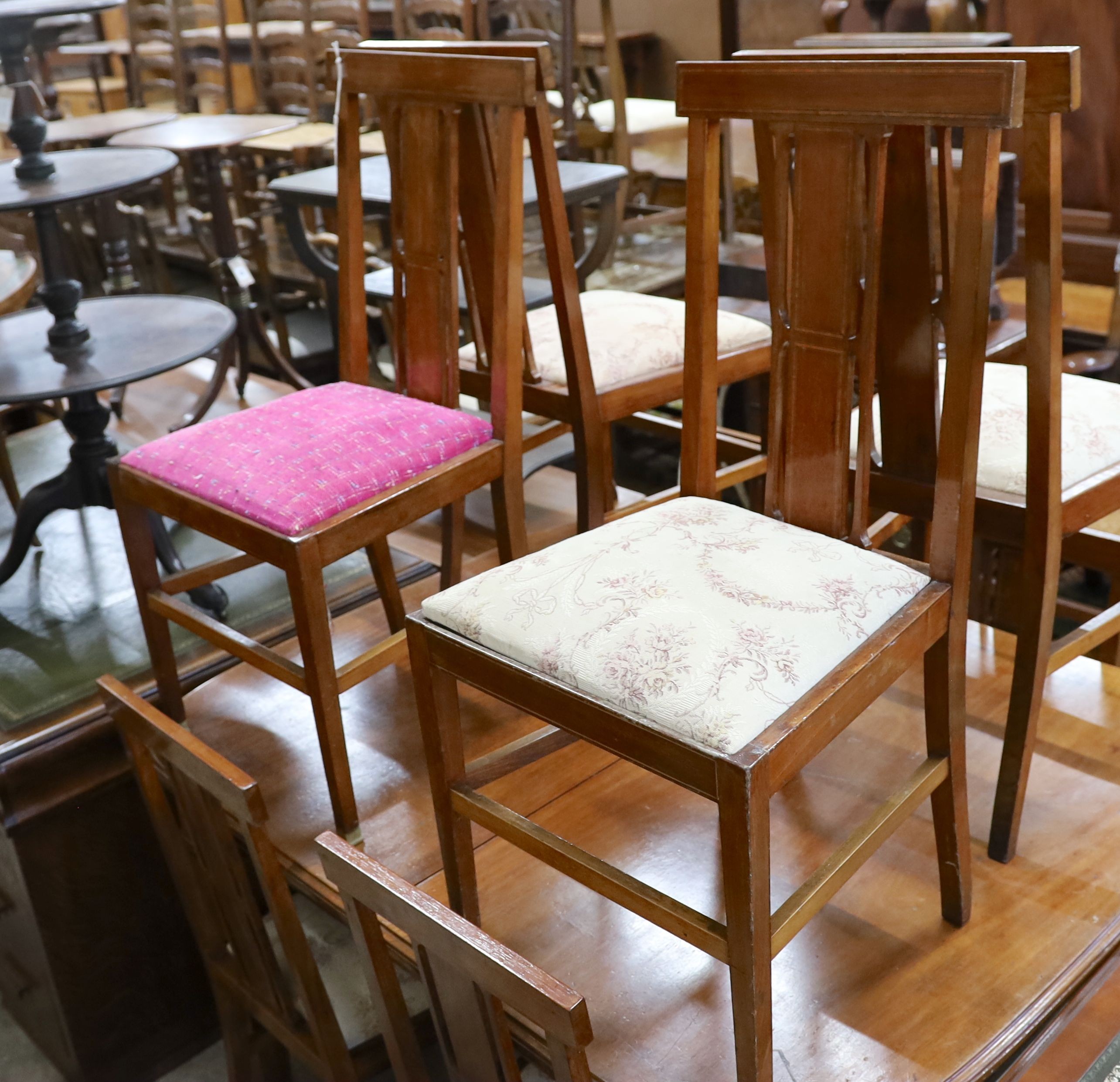 An Edwardian mahogany extending dining table, width 140cm, depth 114cm, height 78cm (no leaves) together with a set of eight Edwardian mahogany satinwood banded dining chairs